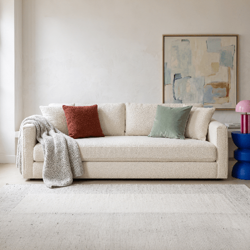 Canapé 3 places avec 4 coussins déco en tissu bouclette beige clair - Collection Denver